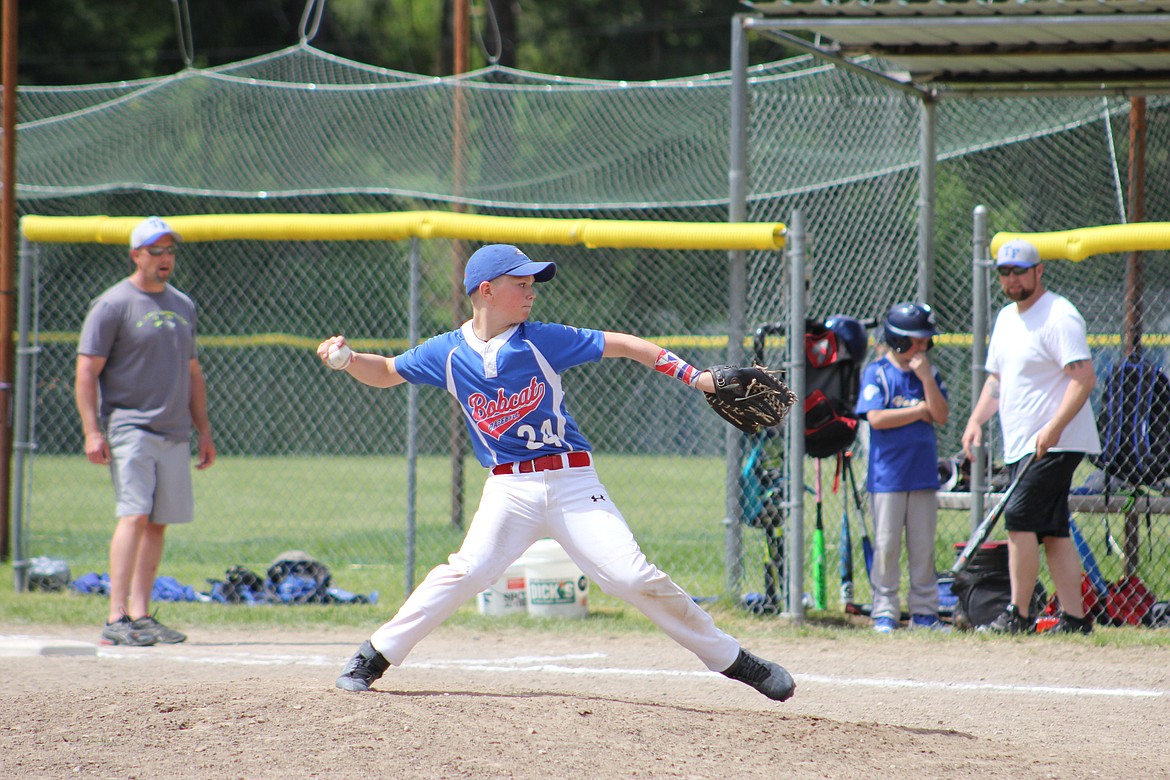 Bobcat Orion Plakke throws a pitch against a Thompson Falls player on a sunny Saturday morning.(Kathleen Woodford/Mineral Independent).