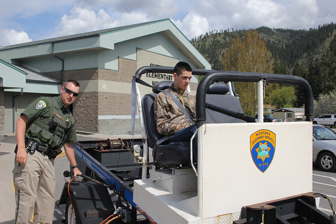 Superior student Kyle Francis takes a ride in the &#147;seatbelt convincer&#148; during the health fair on Saturday. (Kathleen Woodford/Mineral Independent).