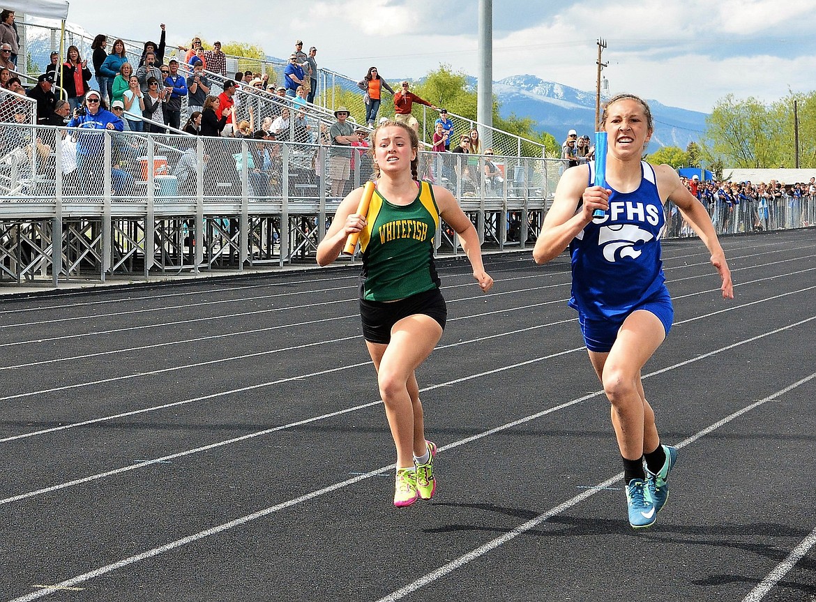 Lydia Kryshak edges a Columbia Falls runner in the 1,600m relay during the Western A divisional meet last weekend in Corvallis. (Photo courtesy Jeff Doorn)