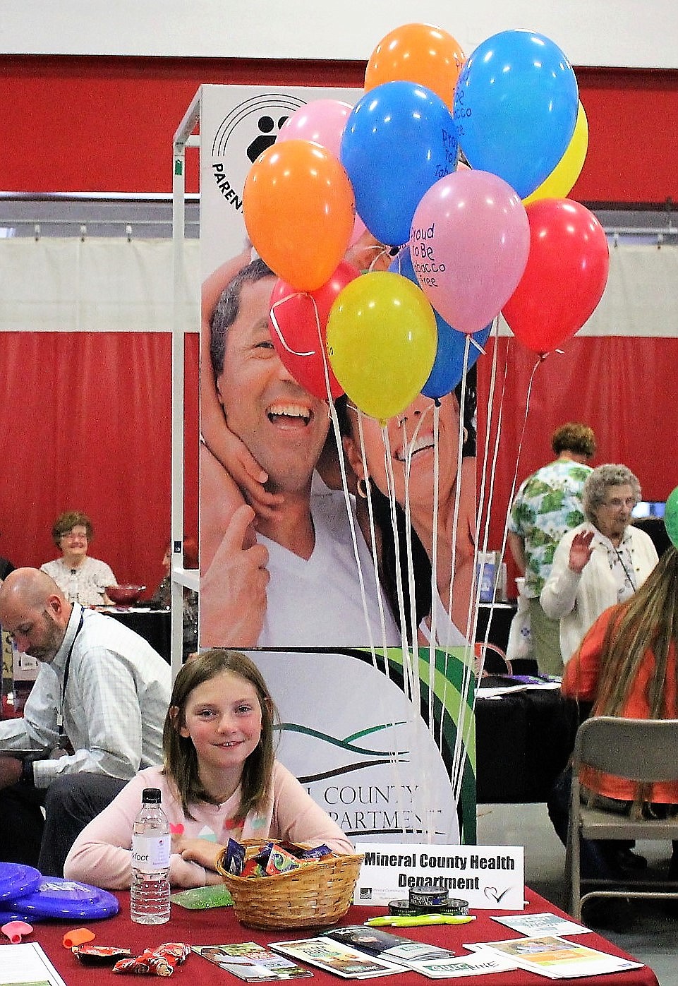 Emma Lommen helps out at the Mineral County Health Department table during Saturday&#146;s health fair. (Kathleen Woodford/Mineral Independent).