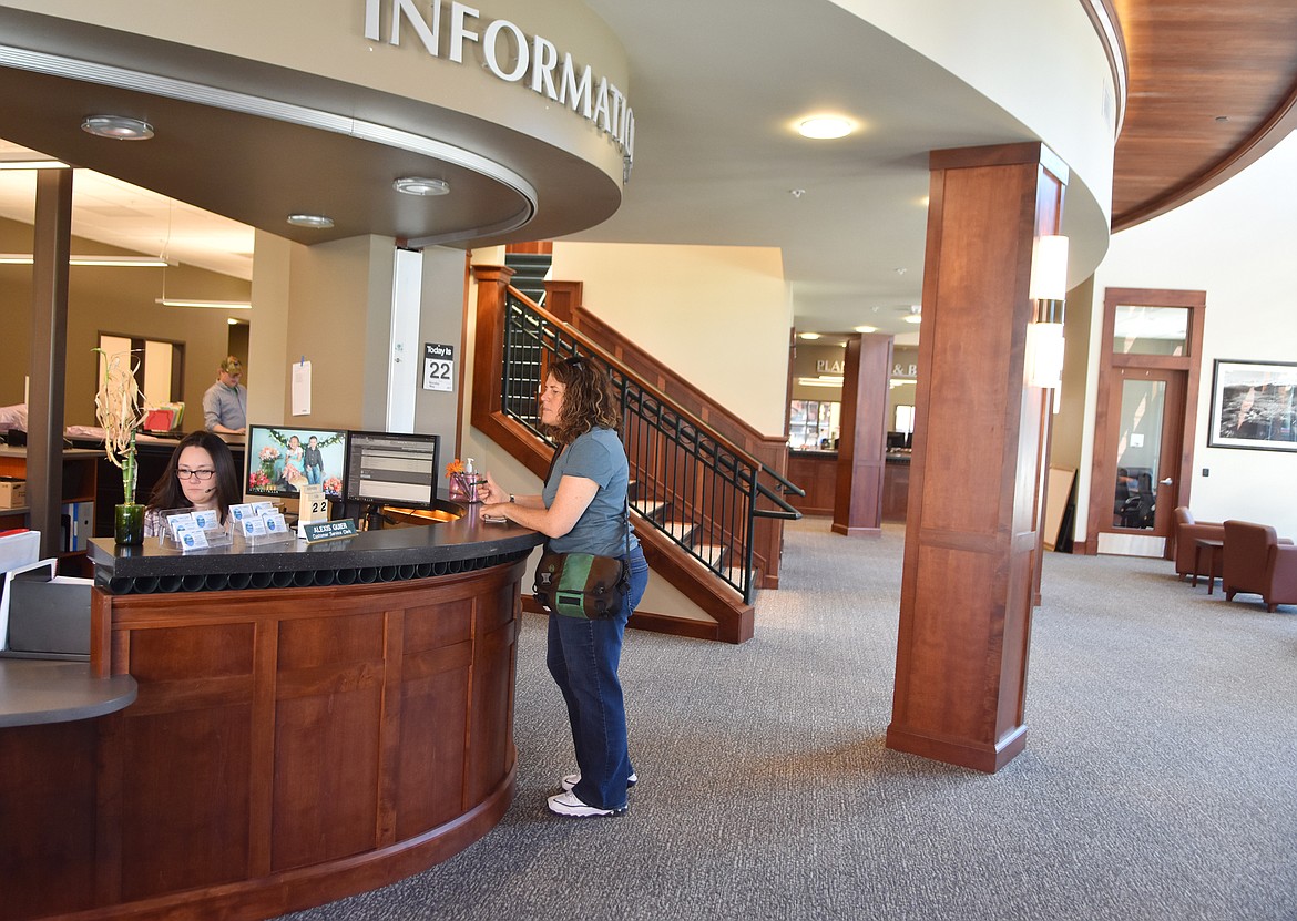 Alexis Guier assists Paula Greenstein Monday morning inside the new City Hall. (Heidi Desch/Whitefish Pilot)