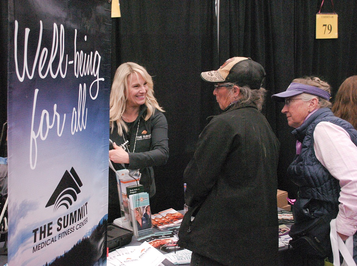 Cathy Lisowski, left, of Summit Fitness shows a grip strength tester to visitors at the Women 4 Wellness Health Fair on May 18. (Brett Berntsen/Lake County Leader)