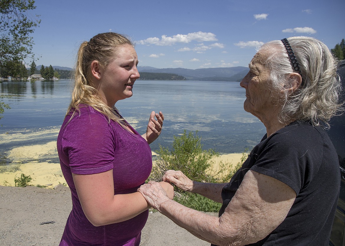 LISA JAMES/PressMissy Holbrook receives condolences from Peggy Trueworthy for losing her dog, Bear, after explaining how Bear drowned in Hayden Lake the day before. Trueworthy's dog had just attempted to jump into the same spot where Bear drowned.