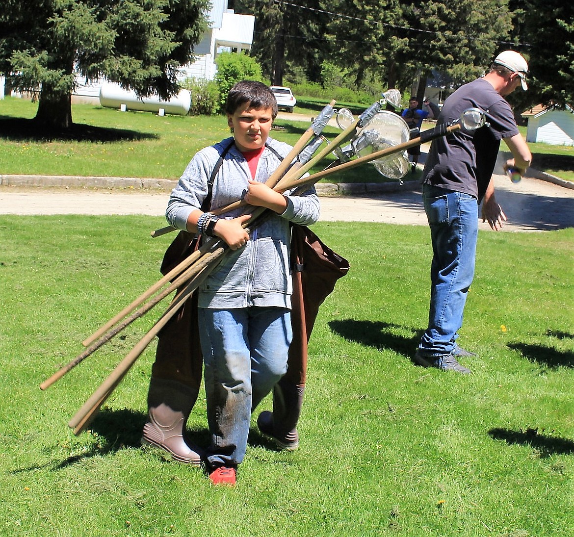 Trevor Wolff carries nets down to the pond for an ecology class during Outdoor School last week. (Kathleen Woodford photos/Mineral Independent).