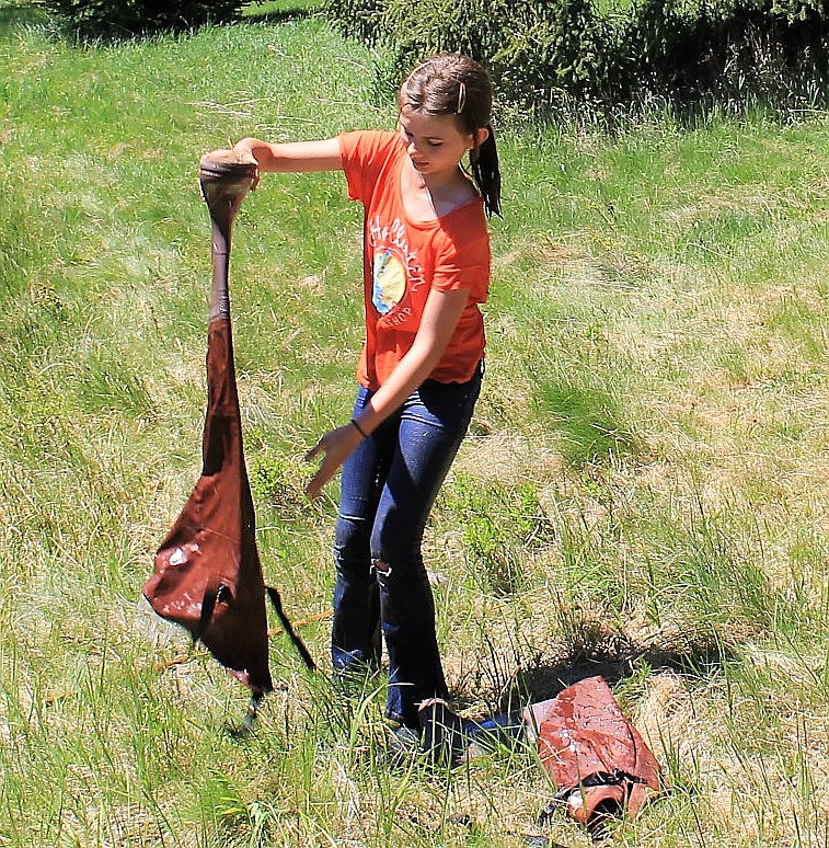 Lorayne Pittsley dumps water from her wader after slipping and falling in the pond at Savenac last week. (Kathleen Woodford/Mineral Independent).