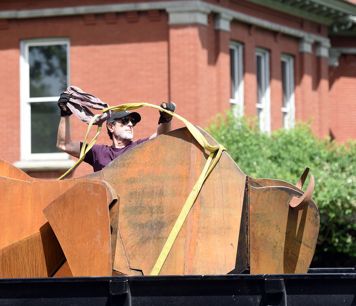 SPANISH ARTIST Manel &Agrave;lvarez helps with the installation of three recently completed iron bison sculptures on Tuesday afternoon, June 6 at the Hockaday Museum of Art. (Brenda Ahearn/Daily Inter Lake)