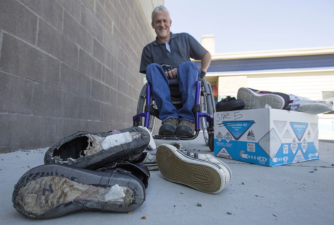 LISA JAMES/Press

Wayne Juneau sits behind a pile of shoes with blown out soles from Borah Elementary School students on Monday. Juneau recently dreamed of the joyous feeling of putting on new shoes, something he has not felt since he lost the use of his legs at the age of 21. The dream inspired him to start Soles for Kids, a program to provide children at Borah Elementary School, where he volunteers, with new shoes.