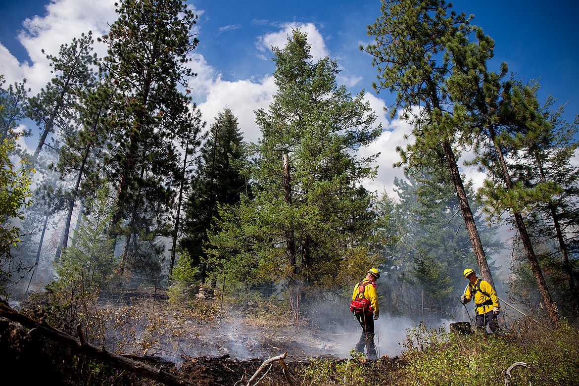 JAKE PARRISH/Press file
Northern Lakes Fire Marshal Tyler Drechsel, left, and firefighter Tyler Denham work the fire line of a roughly 1-acre fire on Aug. 8, 2016, on private property near Highway 53 and Honu Court. Lightning striking a tree sparked the fire.