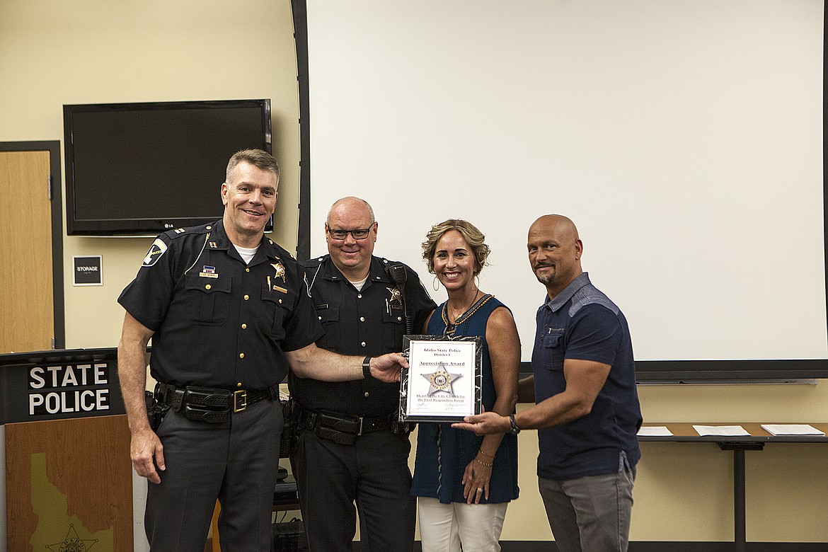 KEITH COUSINS/Press 
Idaho State Police Capt. John Kempf and ISP Cpl. Chuck Robnett pose with pastors Jonathan and Raydeane Owens of Heart of the City Church in Coeur d&#146;Alene. The Owenses accepted an award Friday honoring the church for the creation of its First Responders Room, which gives emergency personnel a quiet place out of the public eye to take a break or have a meal.