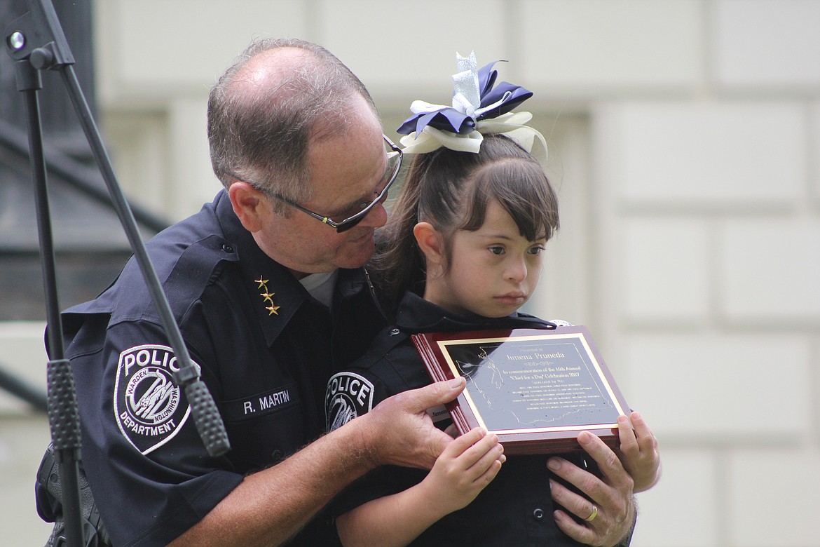 Richard Byrd/Columbia Basin Herald
Warden Police Department Chief Rick Martin awards his department&#146;s honorary Chief for a Day, Jimena Pruneda, a commemorative plaque on Thursday.