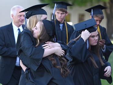Stillwater Christian graduates Kimberly Feist, left, and Haleigh Schwartz embrace before the 2017 Commencement at the school on Friday. Nineteen seniors graduated this year. Darren Kauffman and Haleigh Schwartz were the valedictorians and Abigail Boll was the salutatorian. (Aaric Bryan/Daily Inter Lake)