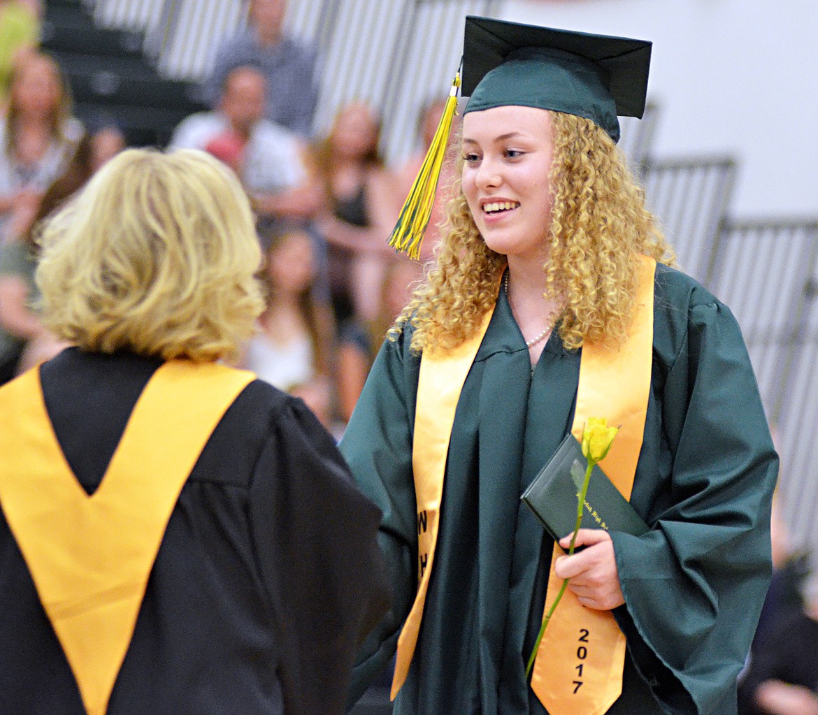 Whitefish High School graduate Sonja Ring shakes hands with Superintendent Heather Davis Schmidt after receiving her diploma Saturday during the commencement ceremony at the high school gym. Whitefish graduated 115 seniors with the class of 2017. (Heidi Desch/Whitefish Pilot)