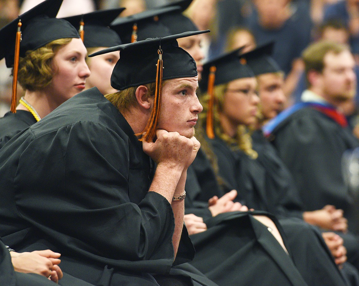 Flathead graduate Jacob Zander listens to classmate Diana Carolina Sierra Correa give the commencement address. (Aaric Bryan/Daily Inter Lake)