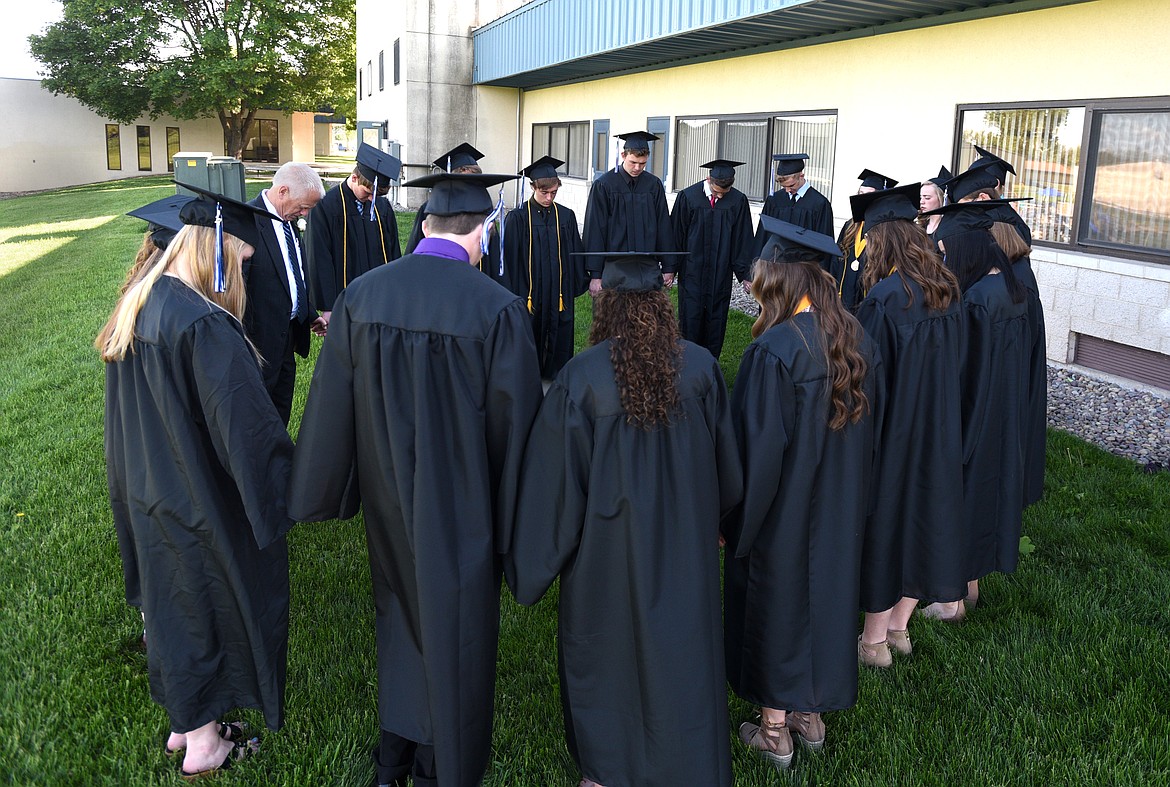 The Stillwater Christian class of 2017 pray before the commencement ceremony at the school on Friday. (Aaric Bryan/Daily Inter Lake)