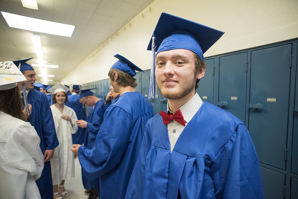 Sportinga  bowtie, Columbia Falls graduate Gabe Keys waits in line for the procession to start during graduation ceremonies Saturday. (Chris Peterson photo)