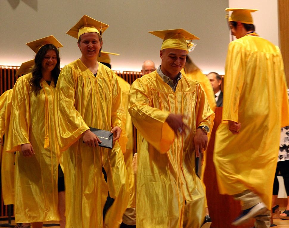 Rodney Harwood/Columbia Basin Herald - Claudiu Szocol dances across the stage leading the 2017 graduates of Moses Lake Christian Academy out of the auditorium to the reception area after Saturday's graduation ceremony at the Moses Lake Civic Center.