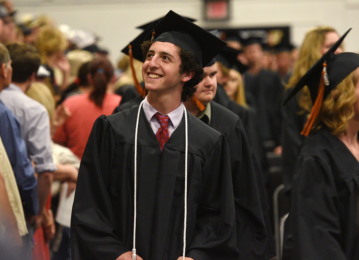 Flathead graduate Noam Tabb looks up to the crowd as he walks into the gym during the 2017 Commencement Ceremony on Friday. (Aaric Bryan/Daily Inter Lake)