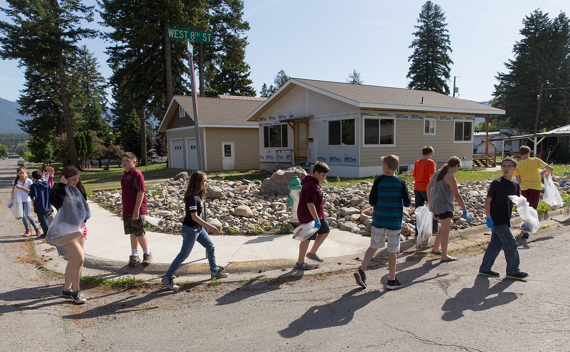 Libby Elementary School sixth-grade students from Kendra Benner's class canvass city streets Wednesday as part of a school-wide cleanup effort. (John Blodgett/The Western News)