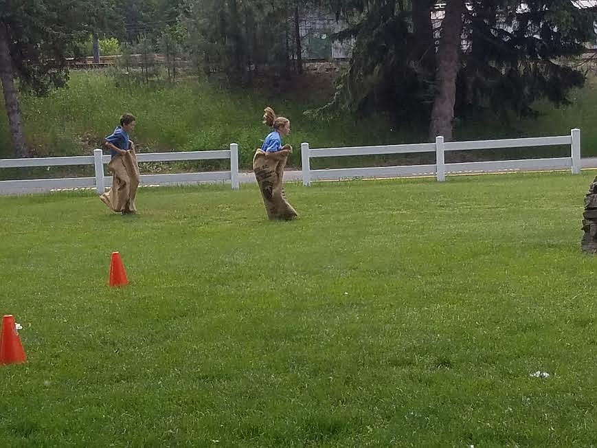 Students bouncing along in the Sack Race.