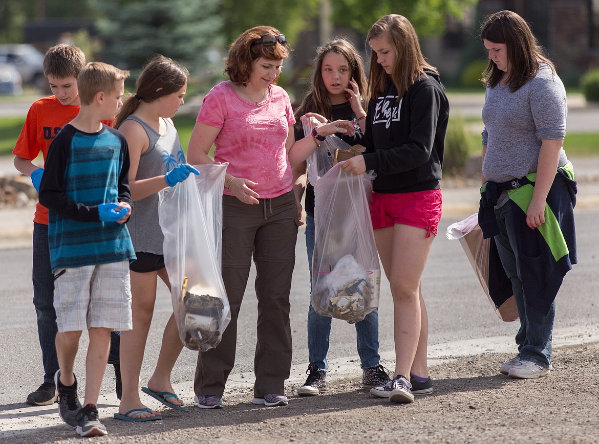 Libby sixth-grade teacher Kendra Benner, fourth from left, with some of her students who took to city streets Wednesday to help clean their community. Students are from left: Colter McMillan, Tyson Fancher, Maria Nelson, Kendra Benner, Alexis Benefield, Aaliyah Spady and Rachelle Swetman-Murray. (John Blodgett/The Western News)