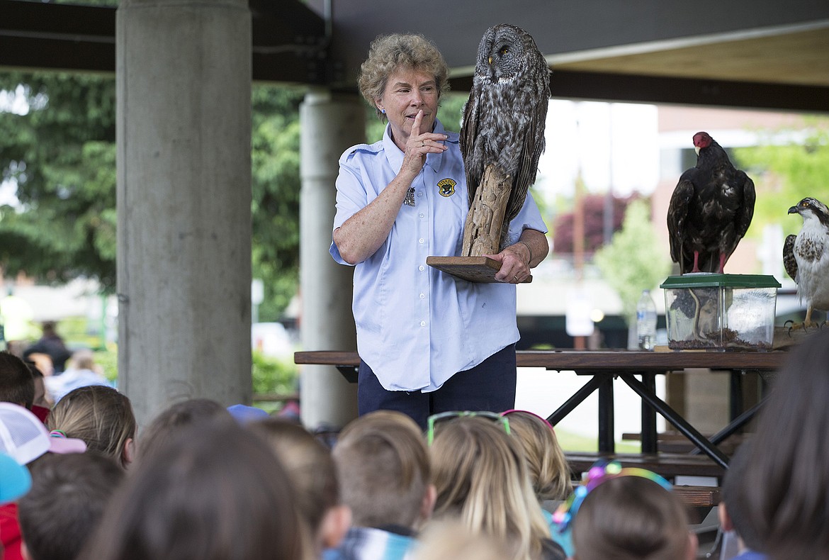 LISA JAMES/Press
Beth Paragamian, A Wildlife Education Specialist for the Department of Fish and Game, holds a taxidermied Great Gray Owl as she urges fifth-graders to be quiet so that a live owl can be brought out during the Birds of Prey presentation at Coeur d&#146;Alene&#146;s first Water Festival at McEuen park on Thursday.  The event, meant to empower students with the knowledge to appreciate, respect and protect our water resources, was sponsored by the Inland Northwest Community Foundation, Kootenai Environmental Alliance, U of I Extension Water Resources and the Water Festival Steering Committee.