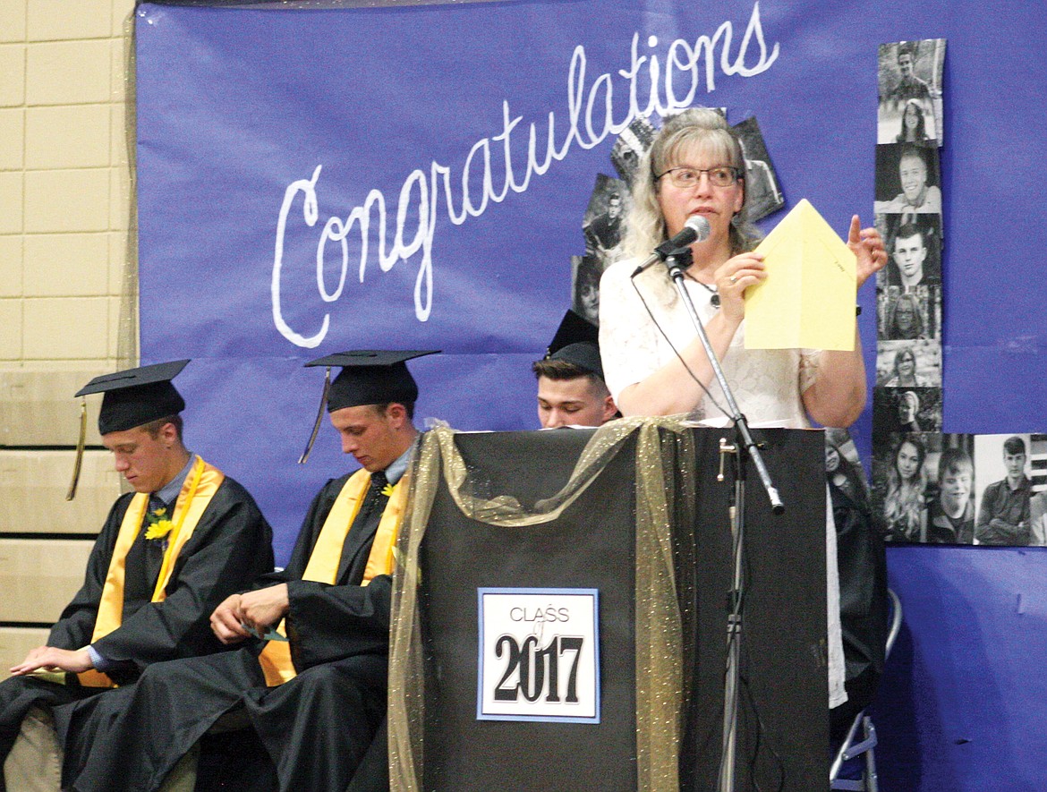 Guest speaker and English teacher  at Libby High School Mrs. Sarah Barrack, instructs the graduating class on folding a paper airplane, using it as an analogy for life. The airplanes were thrown by the class of 2017 along with their caps after they had officially graduated. (Elka Wood/The Western News)