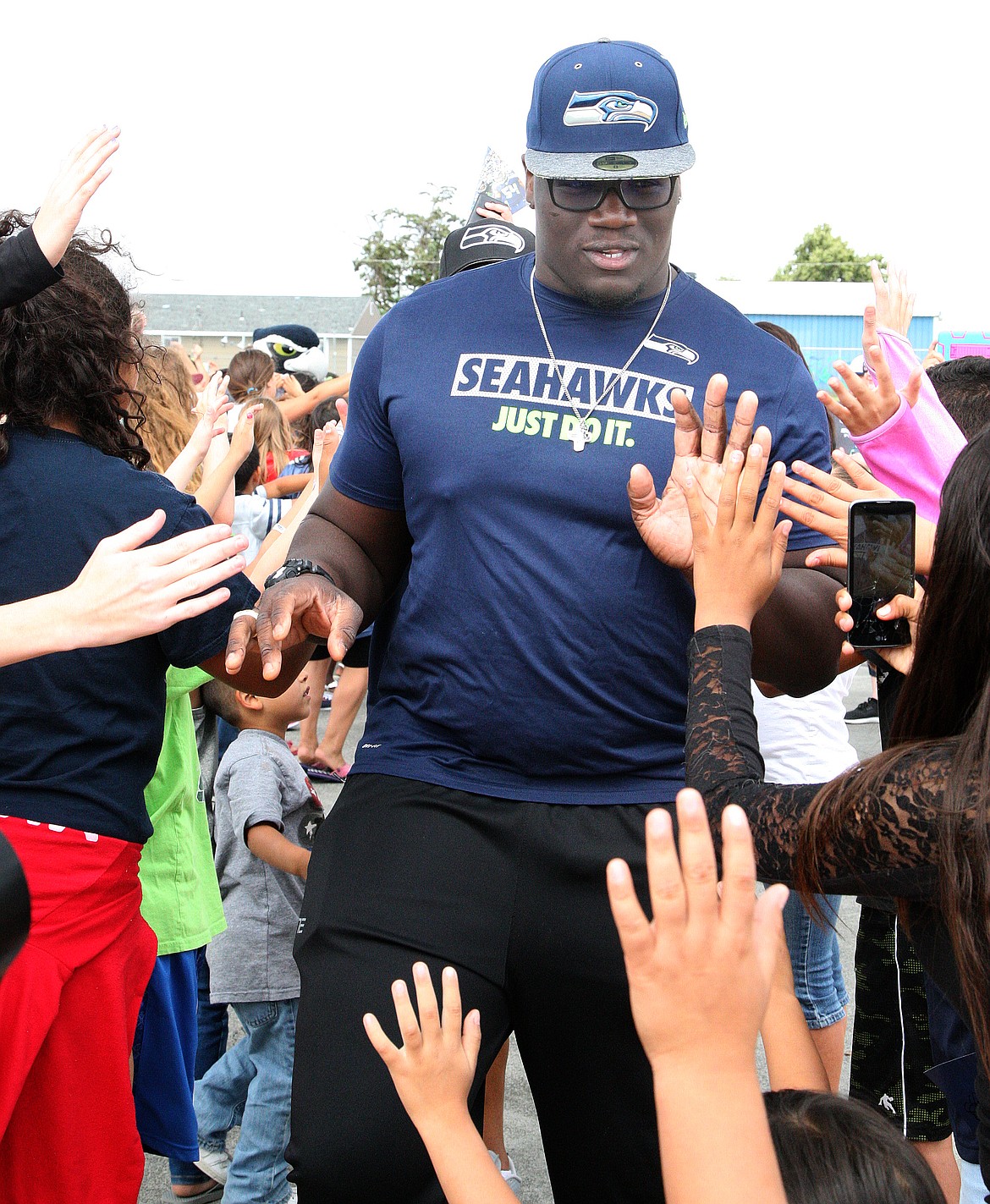 Rodney Harwood/Columbia Basin HeraldSeattle Seahawks 2016 No. 1 draft choice Germain Ifedi high fives his way through a tunnell of fans as part of the 12 Tour last year in Moses Lake. The 2017 Seahawks 12 Tour will make a stop in Othello on June 18 at Lions Park.