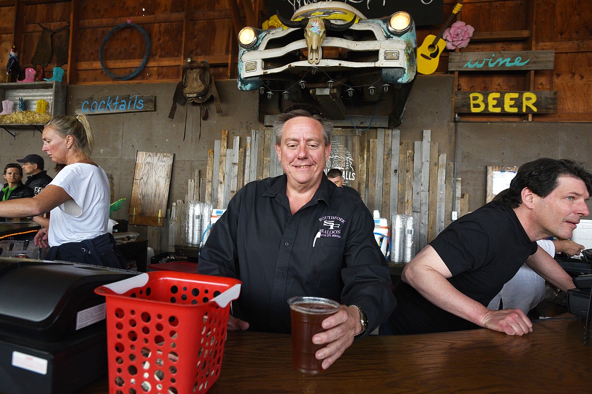 MONTY PRUETT serves a beer at the Columbia Falls Community Market on Thursday, May 25. (Aaric Bryan/This Week in the Flathead)