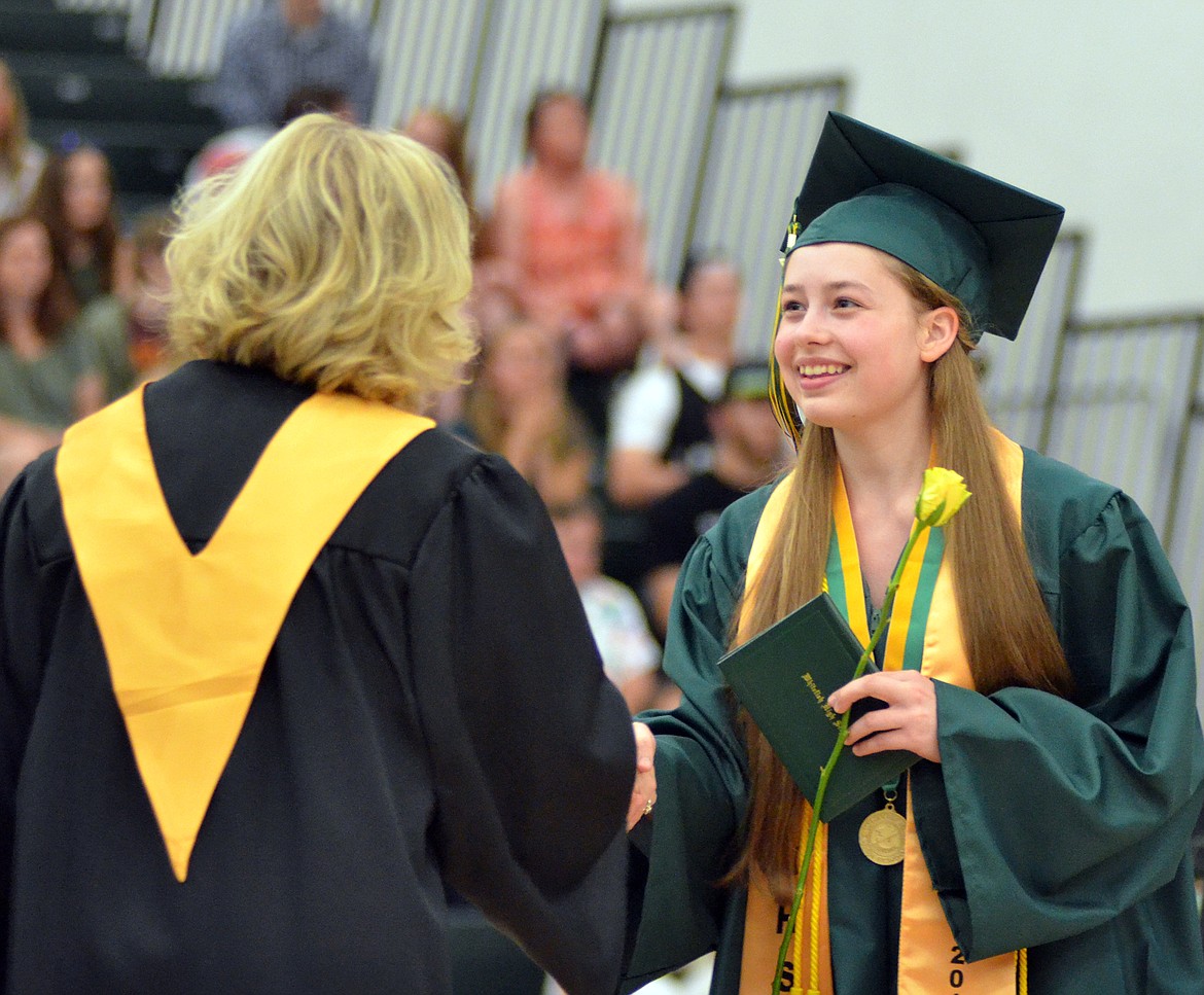 Alora Newbury shakes hands with Superintendent Heather Davis Schmidt after receiving her diploma during the ceremony.