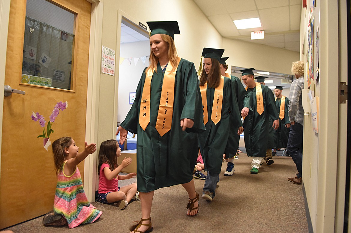 Whitefish High School graduates from the Class of 2017 walked through Muldown Elementary School and Whitefish Middle School Friday afternoon to rounds of applause and high fives. The high school hopes to make the event an annual tradition.