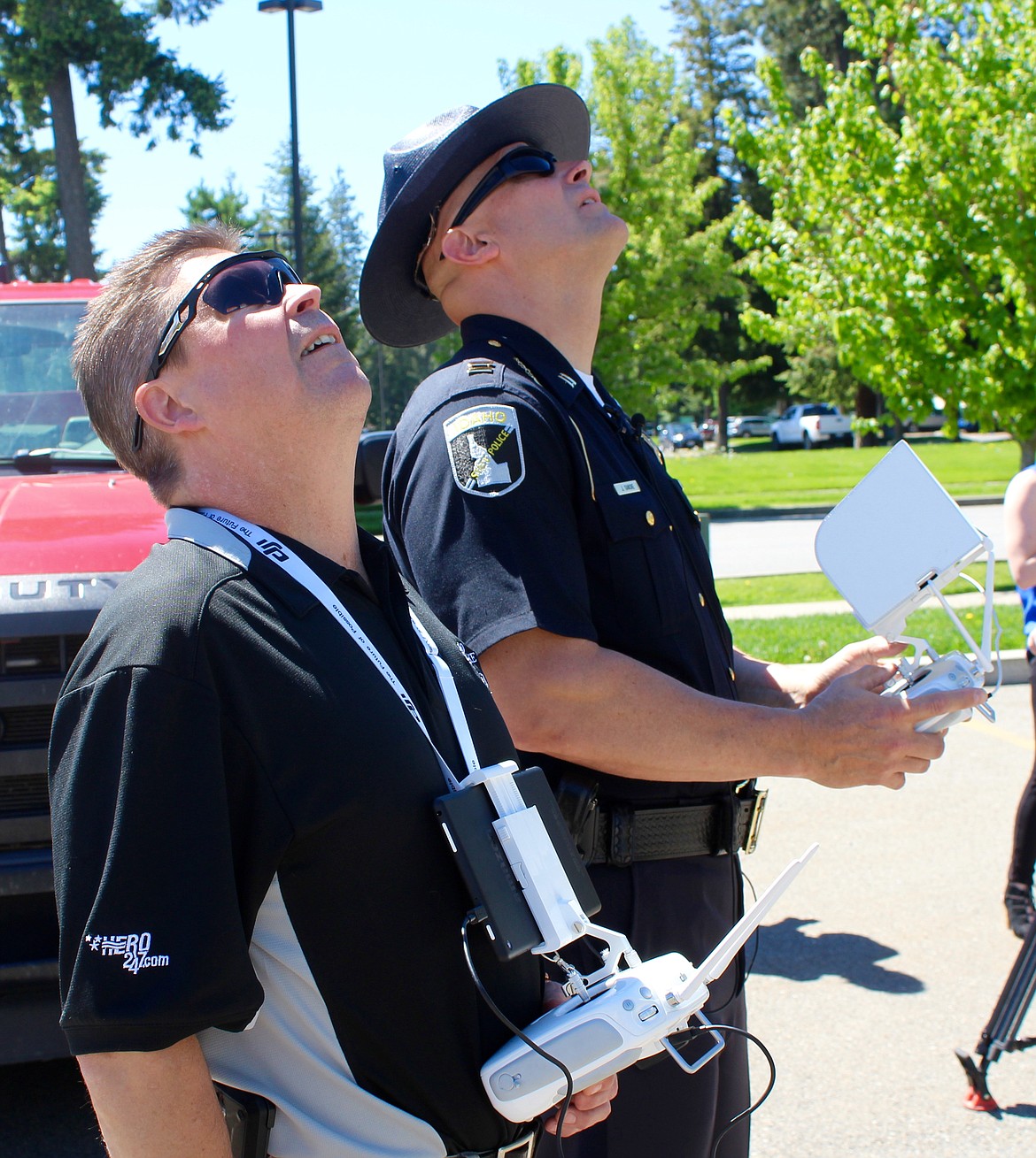 Lt. Alan Oswald (left) and Capt. John Ganske look up at the drone Ganske is flying overhead. Both Oswald and Ganske are certified drone operators with ISP.