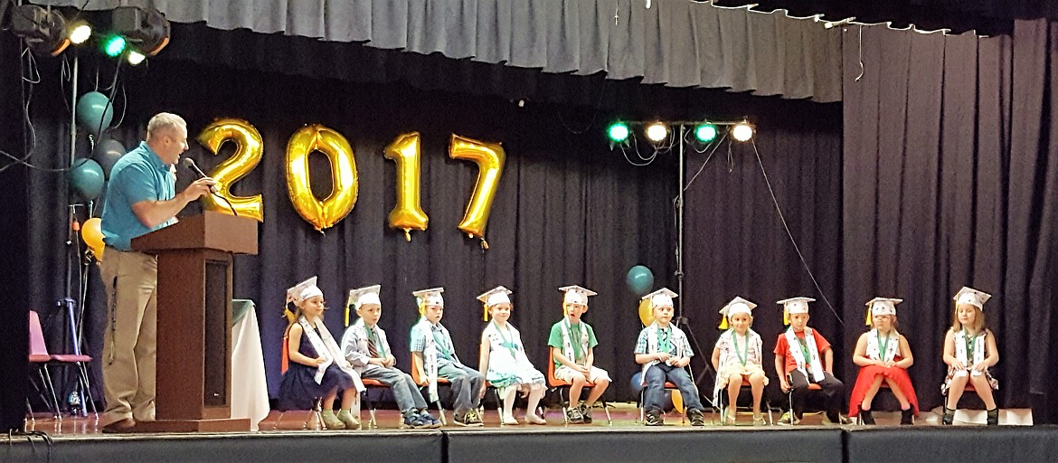 St. Regis Principal Shaun Ball addressed the 2017 kindergarten class during their graduation on June 1. Kindergarten teacher Mallery McEldery introduced the 2017 class to parents, friends and visitors in the school gym, and kindergartener Chet Hill read a poem as part of the program. Ball encouranged the young class to continue their education with the same grit they demonstrated this year. (Photo courtesy of Joe Steele).