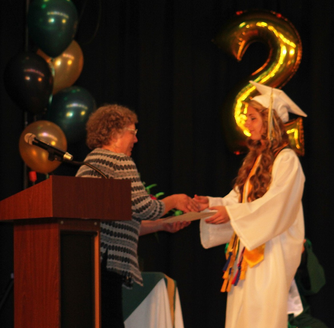 Madison Hill was the class valedictorian for the St. Regis 2017 graduating class. She also received the Christine West Science Scholarship, given by Chris West (left). (Kathleen Woodford/Mineral Independent)