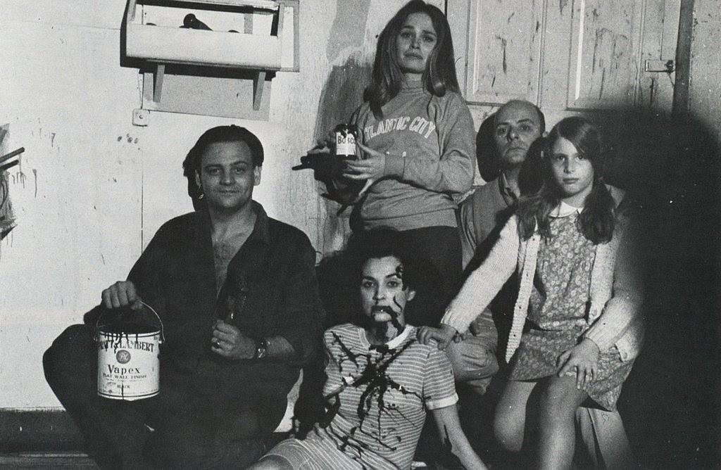 Courtesy photo
George Romero, left, holds a bucket of Bosco Chocolate Syrup in this 1967 photo taken in the basement of the Latent Image in Pittsburgh where many scenes were filmed. Bosco was used as blood in the &#147;Night of the Living Dead.&#148; Left to right: Romero, actress Judith Ridley (standing), Latent Image owner Karl Eastman, young actress Kyra Phillips and a Bosco-covered Marilyn Eastman (seated on the floor).