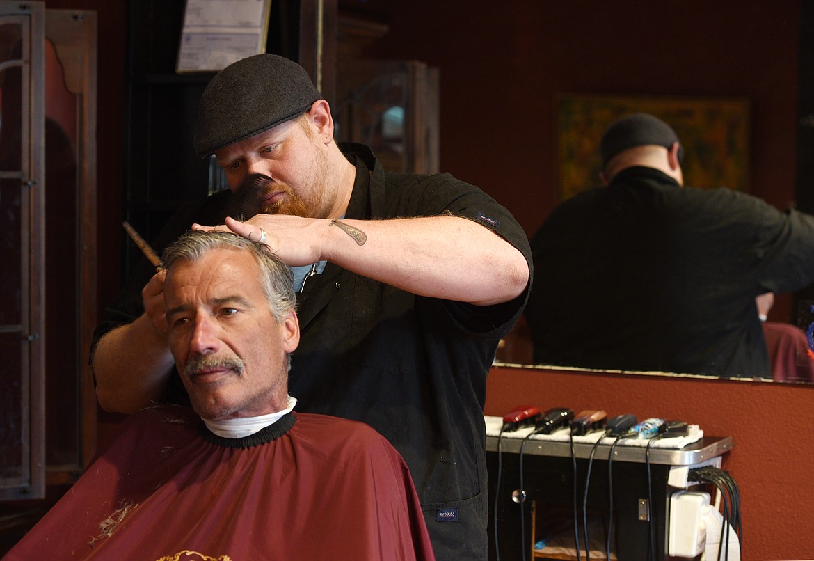 Bobby Beeman cuts Curtis Cain&#146;s hair at the Big B&#146;s Barbershop and Shaving Parlor. (Aaric Bryan/Flathead Journal