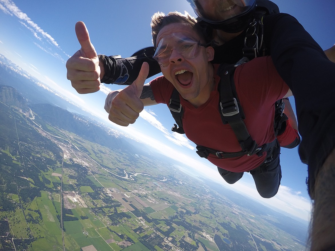 A jumper and a tandem instructor give a thumbs up to the camera during freefall. (Photo courtesy of Skydive Whitefish)