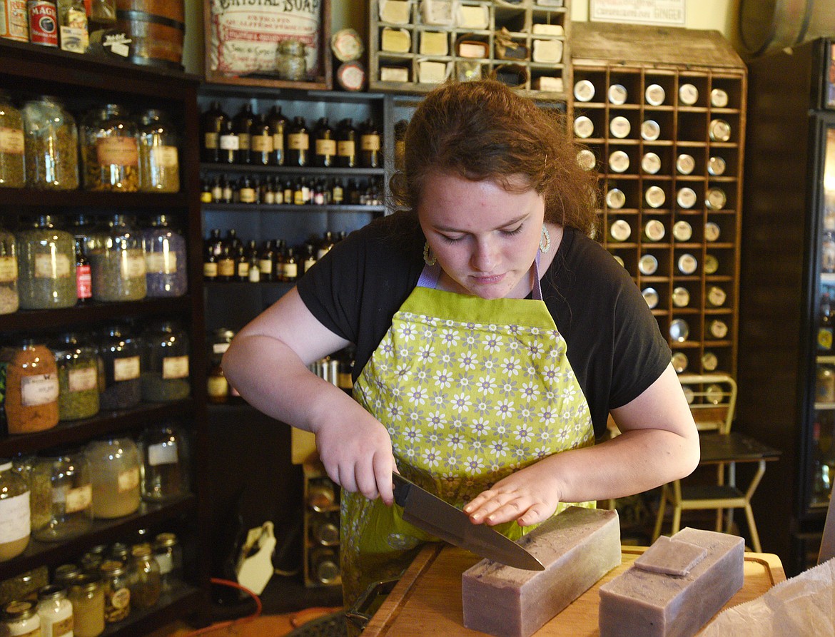 Willow Dawson cuts a bar of lavender soap at the Glacier Ridge Ranch.