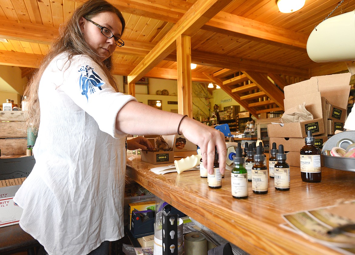 Jennifer Songer packages tinctures to mail at the Glacier Ridge Ranch in Trego on Tuesday. (Aaric Bryan/Daily Inter Lake)