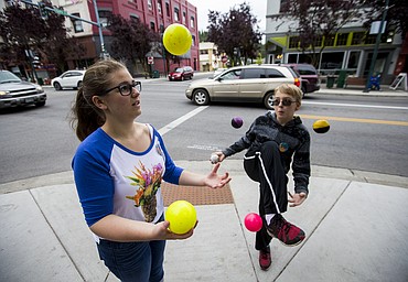LOREN BENOIT/PressPiper and Jamison Wasson juggle at the corner of Sherman Avenue and 4th Street in downtown Coeur d'Alene on Tuesday. A handful of other Sorensen Magnet School alumni gathered downtown to participate in Coeur d'Alene's Street Music Week and to help raise funds for the Post Falls Food Bank.