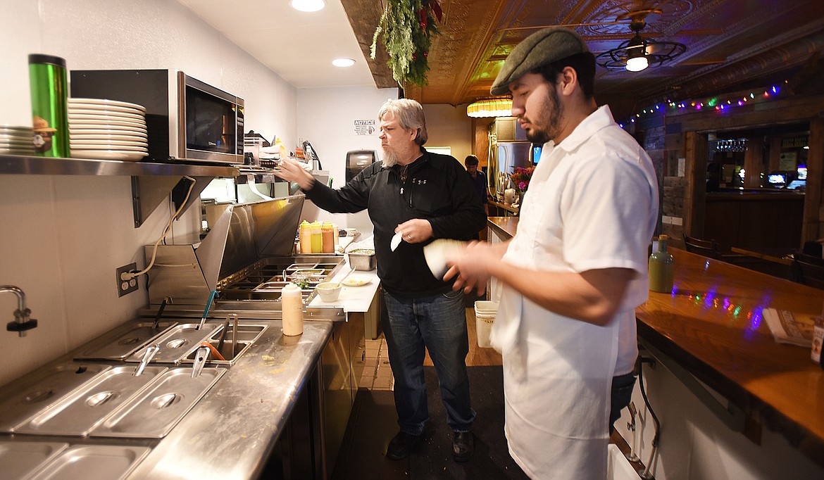 DAVE SHEERAN and Giovanni Lopez add the final touches to dishes before they are served up at Mama Blanca&#146;s on Thursday, December 10, 2016. Sheeran owns the restaurant, which is attached to The Remington bar. (Brenda Ahearn/Daily Inter Lake, file)