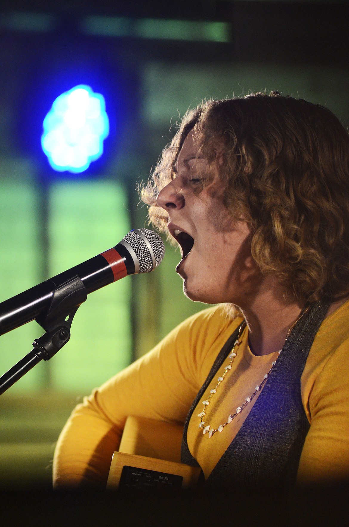 SHANTEL BOLKS sings and plays guitar at a talent show at the Remington Bar in downtown Whitefish on June 13.