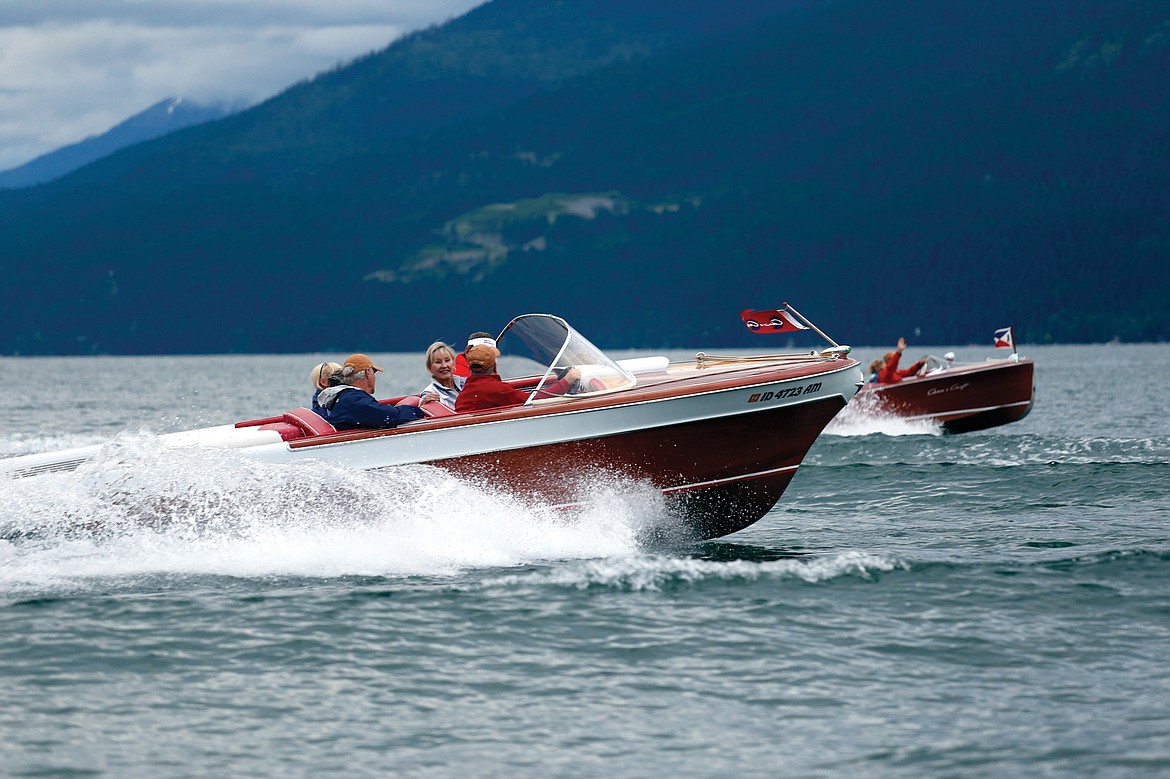 A PAIR of wood boats cruise on Whitefish Lake during the 2015 Whitefish Woody Weekend.