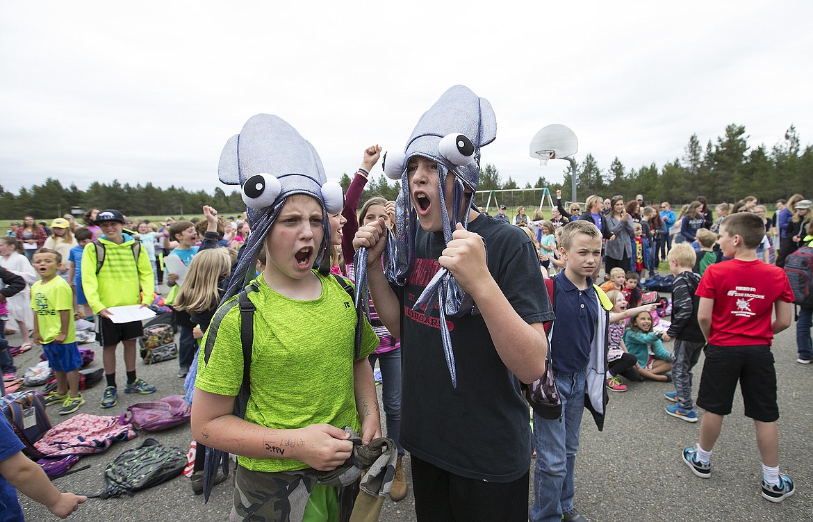 LISA JAMES/Press
Garwood Elementary School sixth-graders Wyatt Aramburu, left, and Damien Cordle sing along Tuesday to rock music performed by Grizzle, a band made up of teachers from the school.