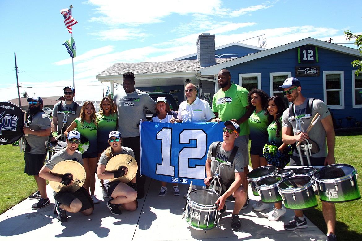 Rodney Harwood/Columbia Basin Herald - The 12 Tour stopped by the Seahawks House on East Oak St. in Othello to visit Roger and Sharon Ensz on their way to Lions Park Sunday morning.