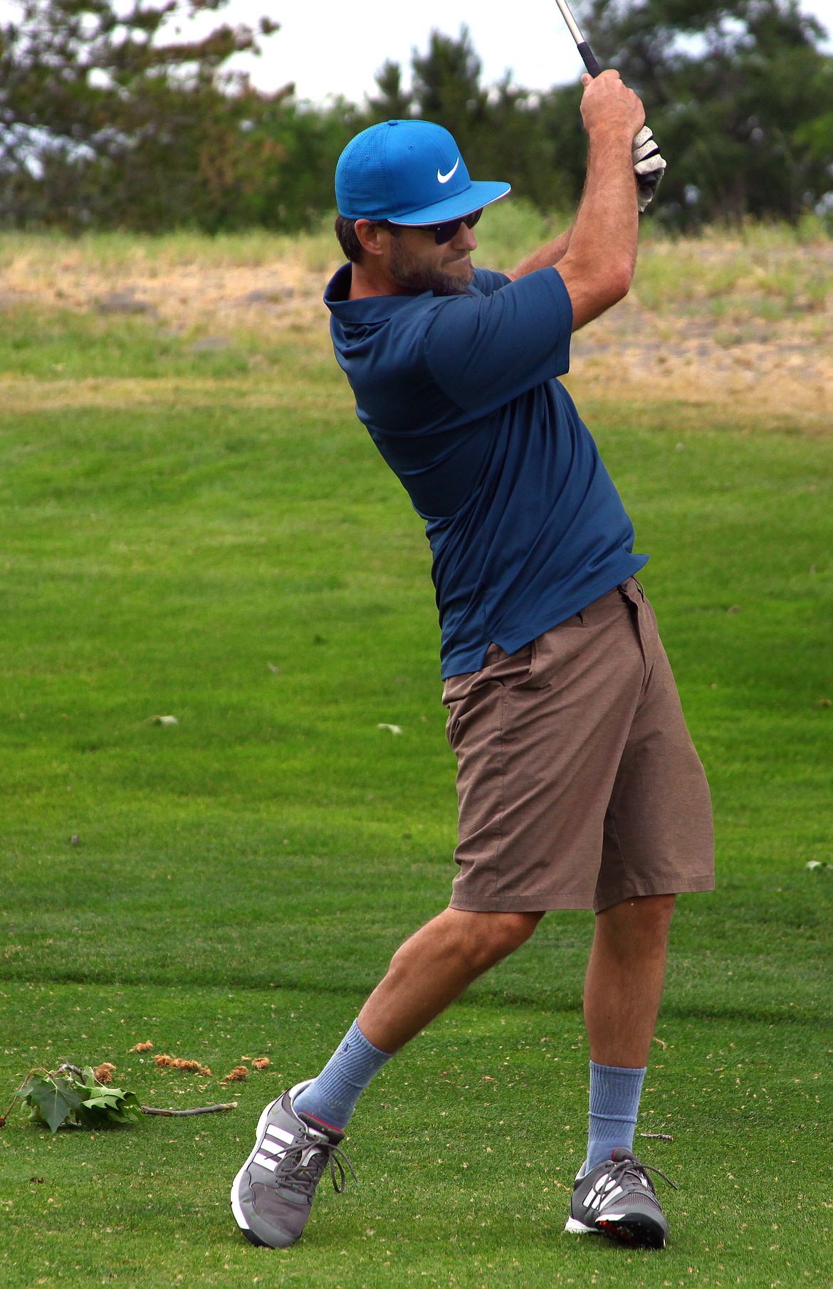 Rodney Harwood/Columbia Basin HeraldColumbia Basin Herald publisher Eric LaFontaine follows his approach shot into the 12th green during Thursday's Newspapers in Education Golf Tournament at the Moses Lake Golf Club.