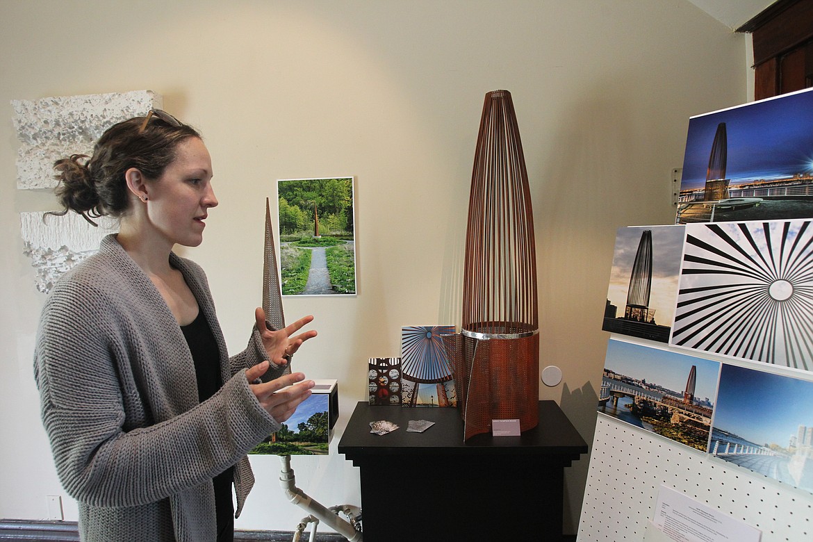 Sculptor Sarah Thompson Moore discusses ideas behind some of her works as she stands near a model of her piece, &quot;Everything Between,&quot; during the Artist Studio Tour on Saturday. &quot;Everything Between&quot; is a 28-foot-tall steel structure that she designed for Riverside Park South on the Hudson River in New York, where it was displayed for a year. She said the piece will soon be installed at a new location in Florida.