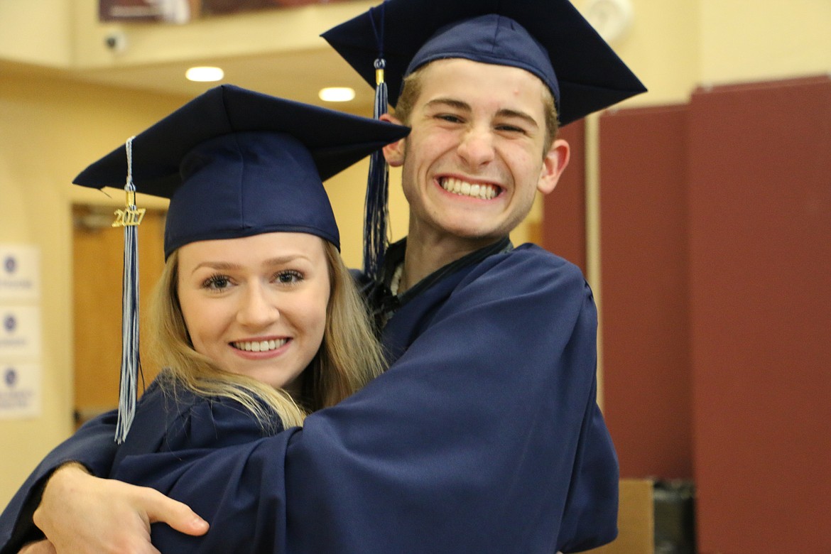 (Photo by MARY MALONE)
Forrest Bird Charter School graduate Alexander Riach, right, gives fellow graduate Angie Orsi, left, a big squeeze as they prepared to line up for their graduation ceremony Saturday in North Summit Church.