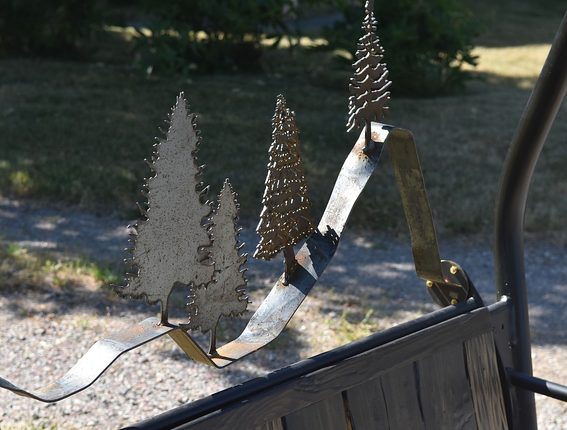 Michelle Saurey, Mark Baumbach and Terence Gill worked together to create a bench that combines woodwork and metalwork. The bench sits on the lawn at the Walking Man Frame Shop and Gallery.