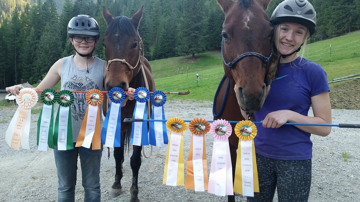 Courtesy photo
Local 4-H participants Jaden House and Erin Anderson show off their ribbons from the Diablo 4-H Open Horse Show in Coeur d&#146;Alene last month. Jaden House is on the left with horse Max and Erin Anderson on the right with horse Chloe.
