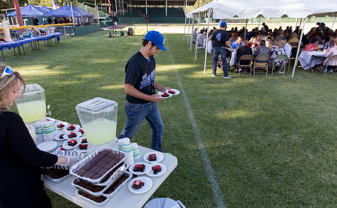 Tim Carvey serves dessert during Dinner on the Diamond at Lee Gehring Field in Libby Friday, June 9, 2017.